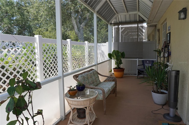 sunroom / solarium featuring vaulted ceiling