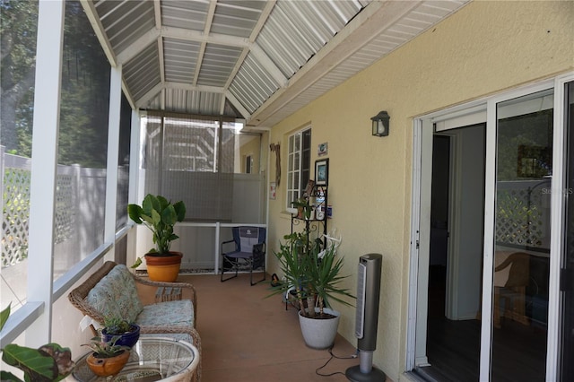 sunroom / solarium featuring lofted ceiling