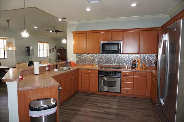 kitchen featuring sink, dark hardwood / wood-style floors, kitchen peninsula, appliances with stainless steel finishes, and ornamental molding