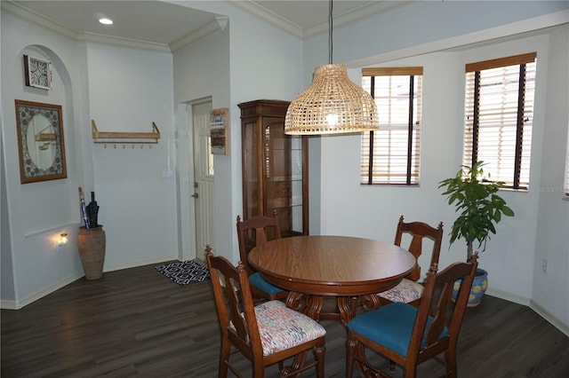 dining space featuring dark wood-type flooring and ornamental molding