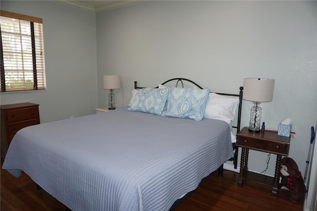 bedroom featuring dark wood-type flooring and ornamental molding