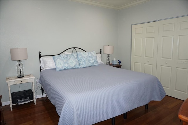 bedroom featuring dark hardwood / wood-style flooring, a closet, and ornamental molding