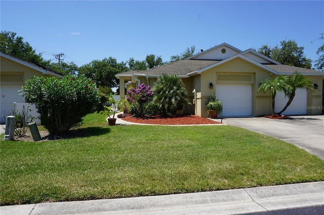 single story home with a front yard and a garage