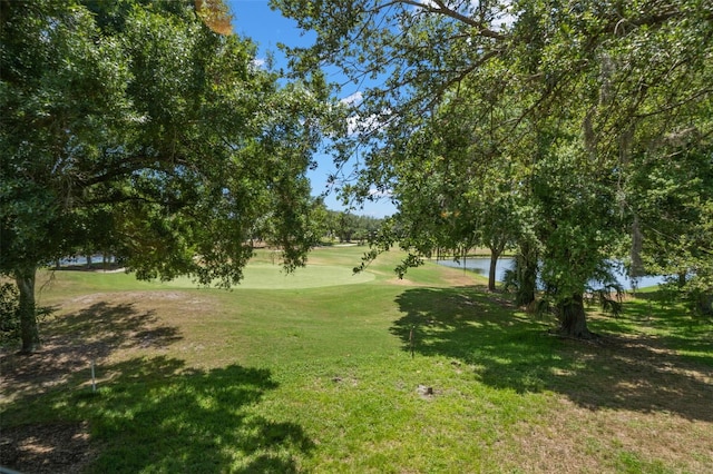 view of home's community with a yard and a water view