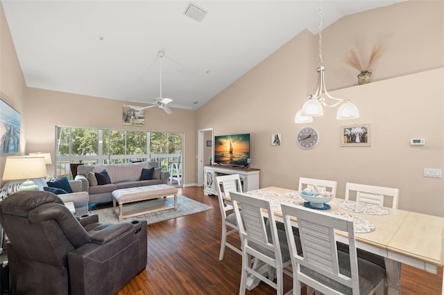 interior space featuring dark hardwood / wood-style floors, ceiling fan with notable chandelier, and high vaulted ceiling