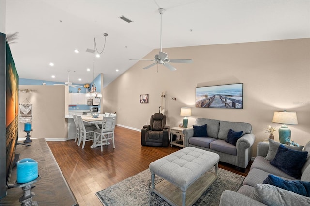 living room featuring vaulted ceiling, ceiling fan, and dark hardwood / wood-style flooring