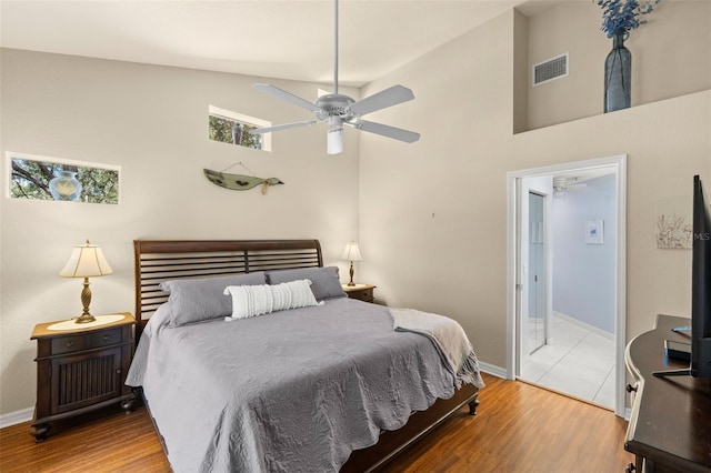 bedroom featuring ceiling fan, high vaulted ceiling, and hardwood / wood-style floors