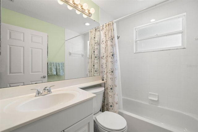 full bathroom with vanity, shower / tub combo with curtain, and toilet