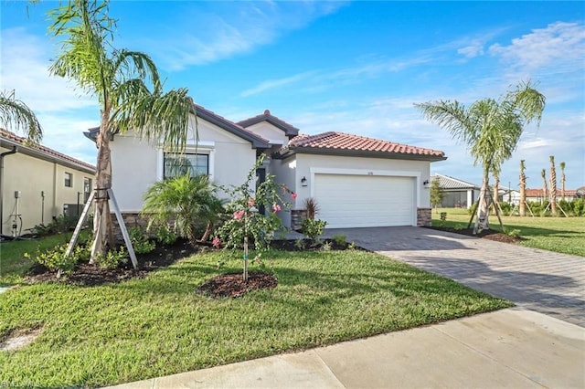 mediterranean / spanish house with a front lawn and a garage