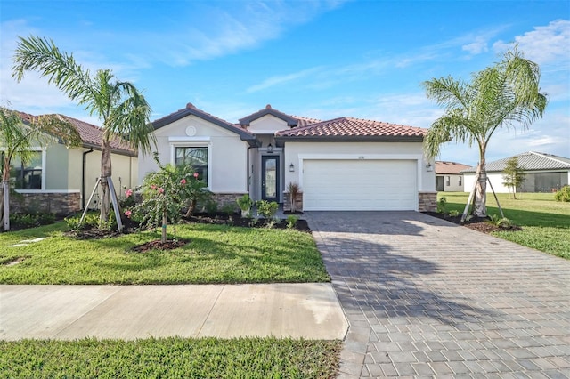 mediterranean / spanish home with a garage and a front lawn