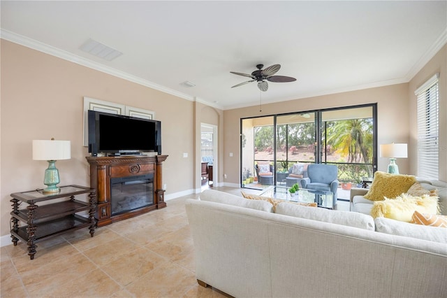 tiled living room with ceiling fan and crown molding