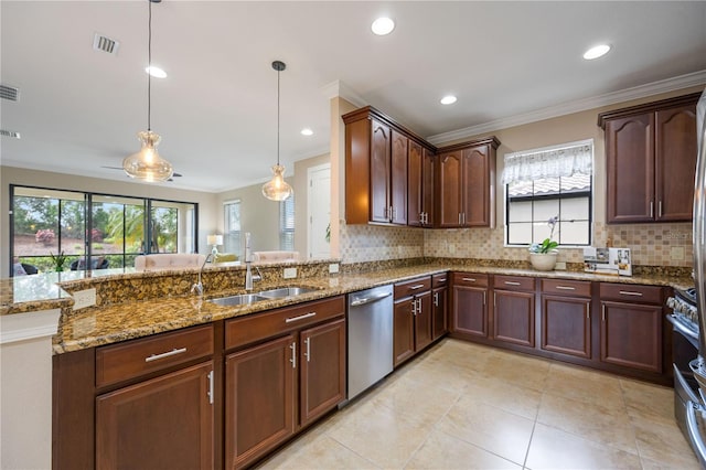 kitchen featuring kitchen peninsula, crown molding, decorative light fixtures, and appliances with stainless steel finishes