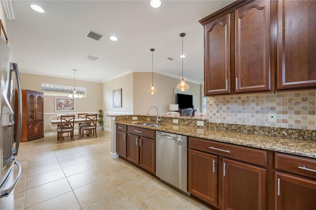 kitchen featuring stone counters, sink, stainless steel appliances, crown molding, and decorative light fixtures