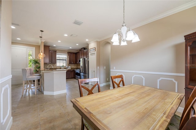 tiled dining space featuring crown molding and a notable chandelier