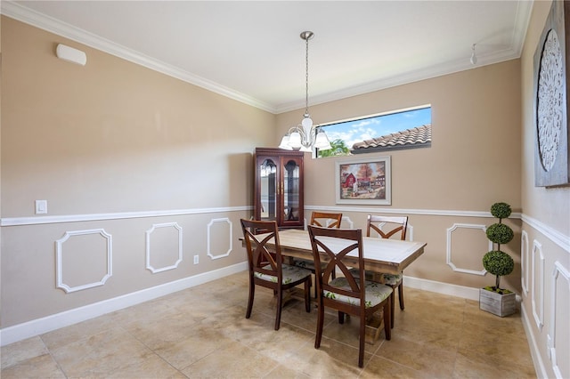 dining space with crown molding and a chandelier