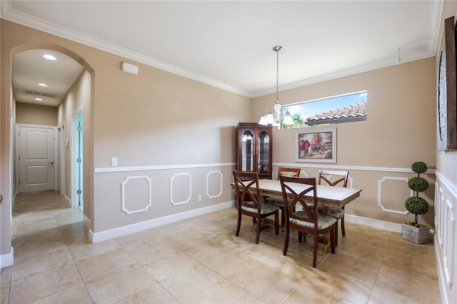 dining room with a chandelier, light tile patterned floors, and ornamental molding