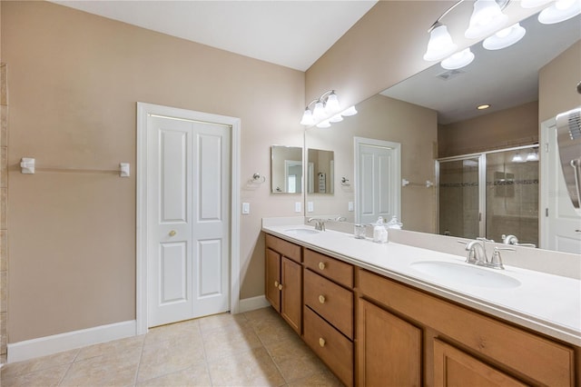 bathroom featuring tile patterned flooring, vanity, and walk in shower