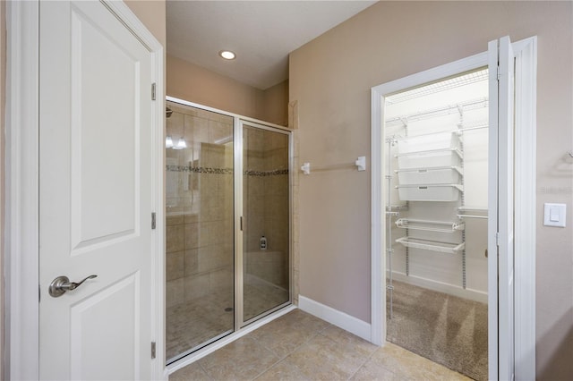 bathroom with tile patterned flooring and an enclosed shower