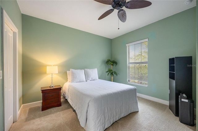 carpeted bedroom featuring ceiling fan