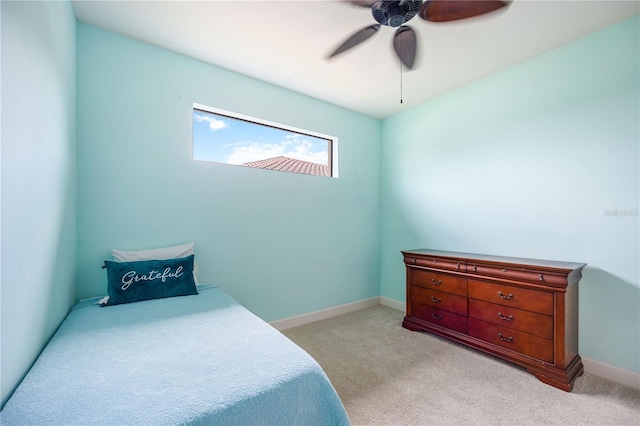 bedroom with ceiling fan and light colored carpet