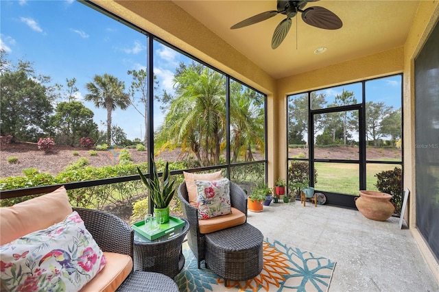 sunroom / solarium featuring ceiling fan and a wealth of natural light