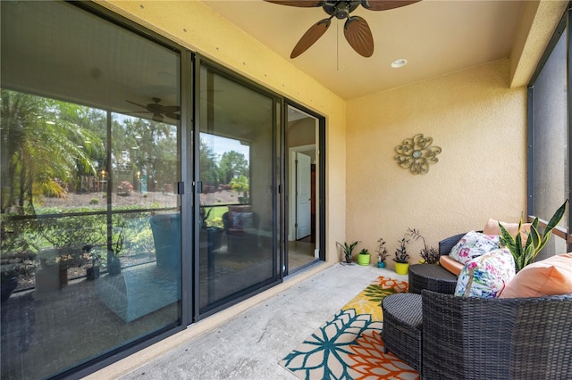 sunroom / solarium featuring ceiling fan