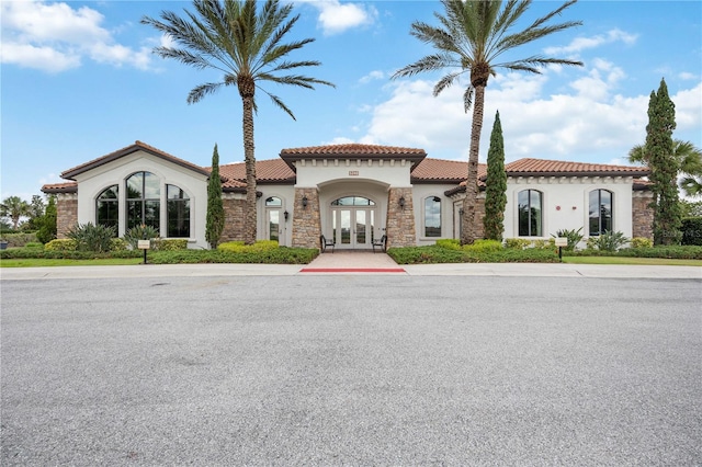 mediterranean / spanish-style home with french doors