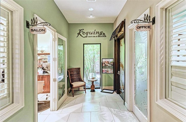 doorway with light tile patterned floors