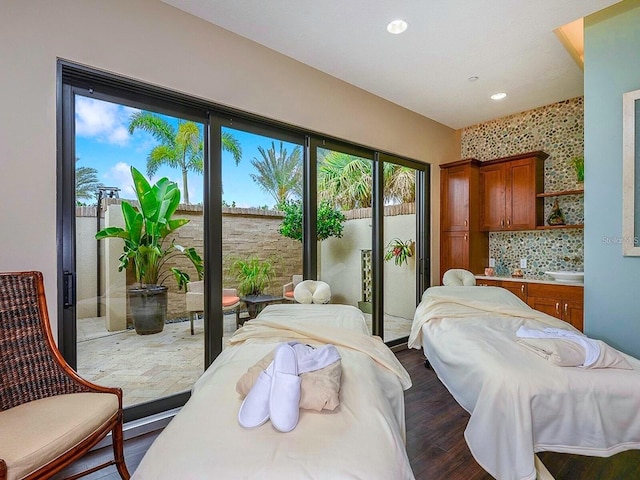 bedroom featuring access to outside and dark hardwood / wood-style floors