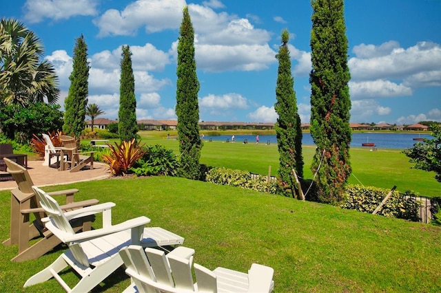 view of yard featuring a patio area and a water view