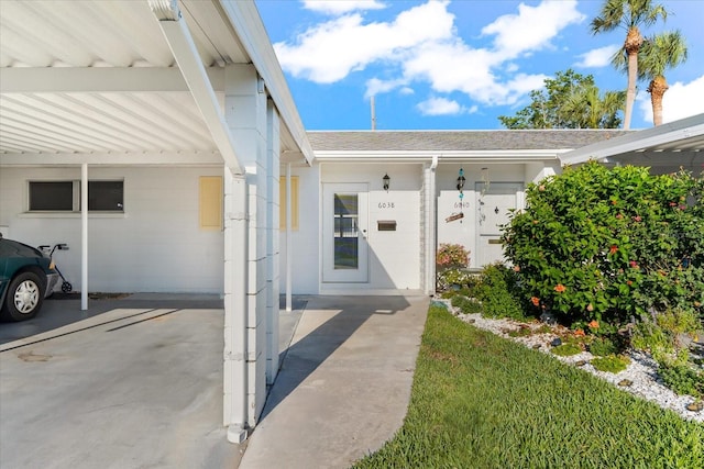 doorway to property featuring a carport