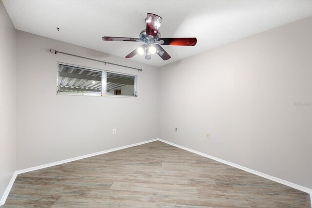 empty room featuring ceiling fan and hardwood / wood-style flooring