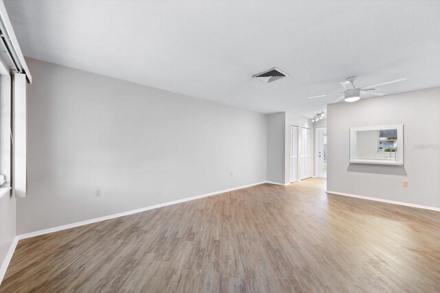 unfurnished living room with light hardwood / wood-style flooring and ceiling fan