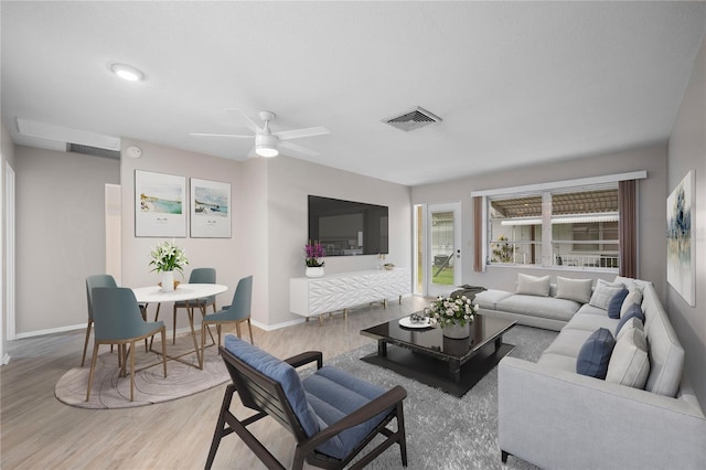 living room featuring ceiling fan and light hardwood / wood-style flooring