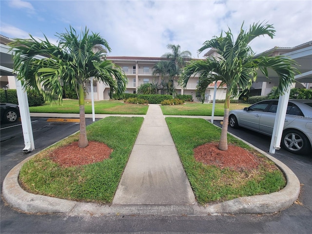 view of home's community with a yard