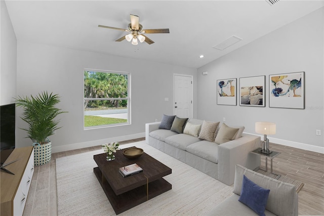 living room featuring hardwood / wood-style flooring, ceiling fan, and vaulted ceiling