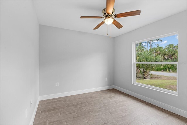 spare room featuring ceiling fan and a wealth of natural light