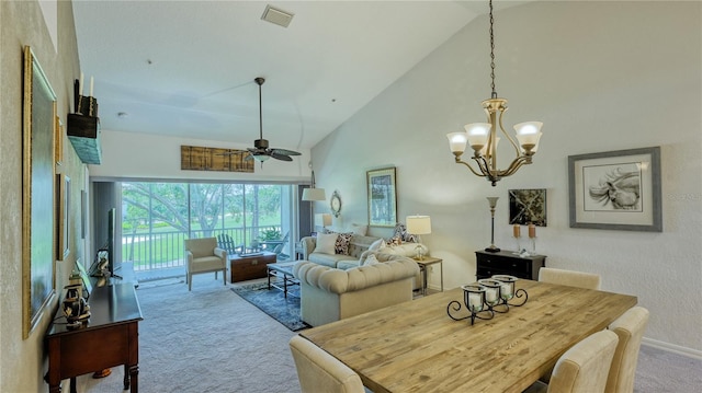 dining room with carpet flooring, high vaulted ceiling, and ceiling fan with notable chandelier