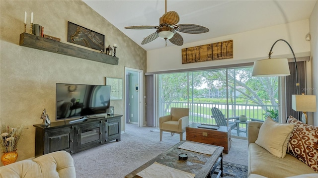 carpeted living room with high vaulted ceiling and ceiling fan