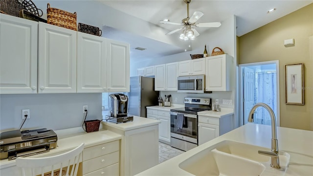 kitchen featuring white cabinets, ceiling fan, and stainless steel appliances