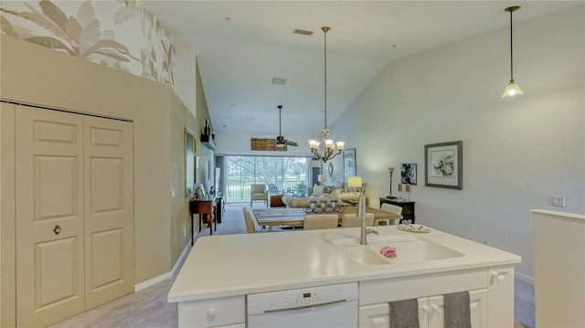 kitchen with dishwasher, light colored carpet, white cabinets, high vaulted ceiling, and pendant lighting