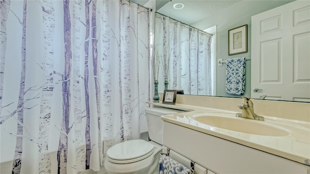 bathroom featuring vanity with extensive cabinet space and toilet