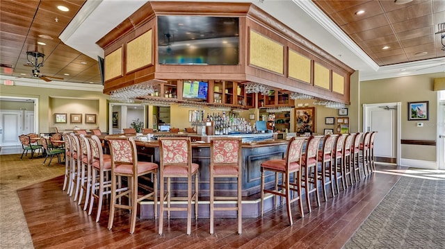 bar with a tray ceiling, wood ceiling, and crown molding