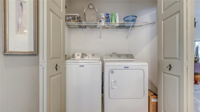 clothes washing area featuring separate washer and dryer