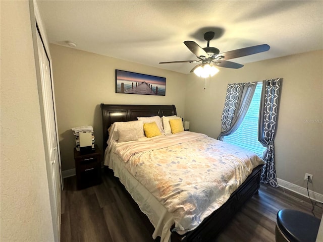 bedroom with a closet, ceiling fan, and dark hardwood / wood-style flooring