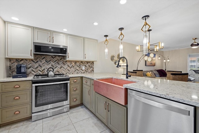 kitchen with stainless steel appliances, light tile flooring, backsplash, and decorative light fixtures