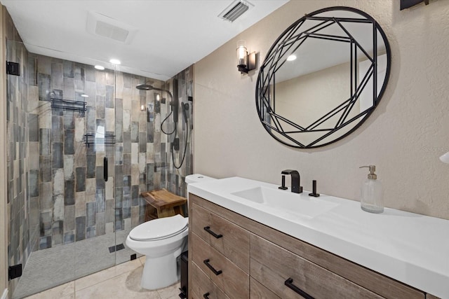 bathroom with tile floors, walk in shower, toilet, and vanity