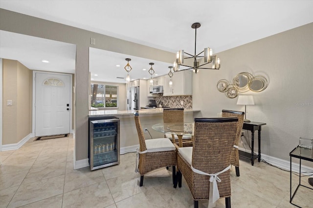 tiled dining room with wine cooler and a chandelier