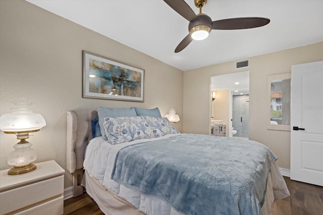 bedroom featuring ceiling fan, connected bathroom, and dark wood-type flooring