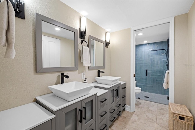 bathroom featuring dual vanity, walk in shower, tile flooring, and toilet